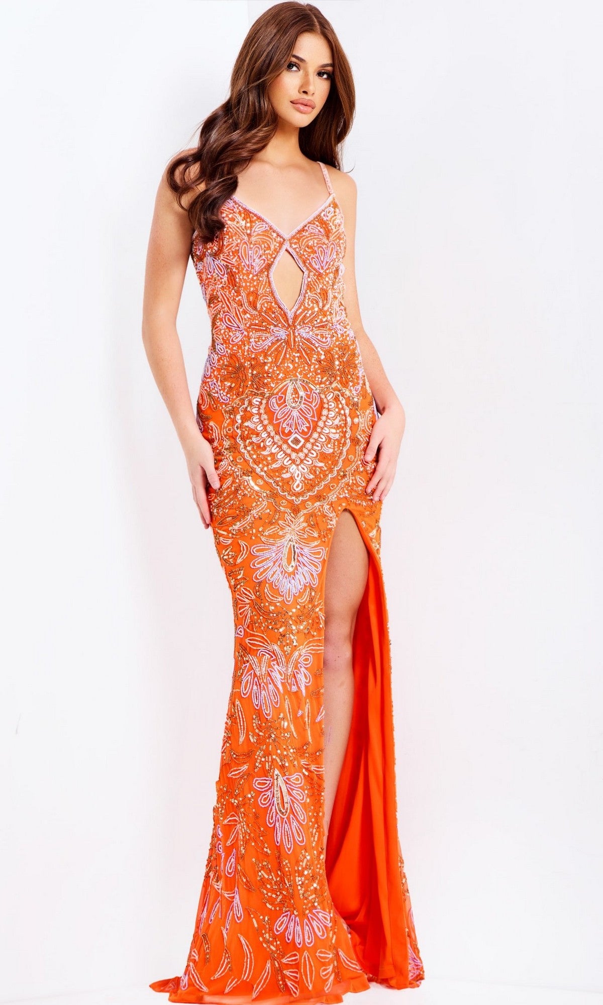 A woman wearing the Jovani 45268 long prom dress in orange, with intricate sequin beadwork, a front keyhole cutout, and a thigh-high slit, stands against a white background.